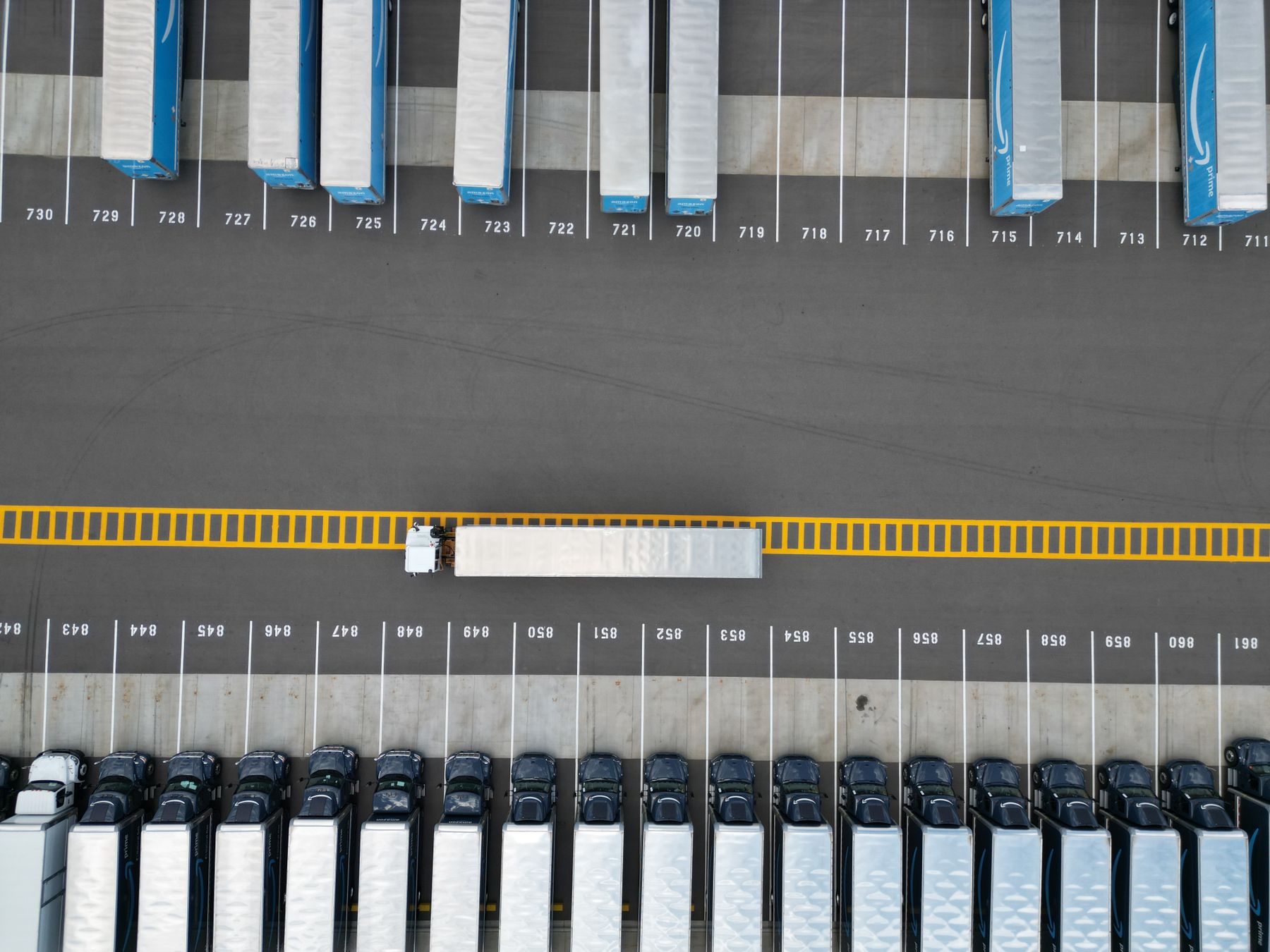 An aerial view of truck trailers in a freight yard